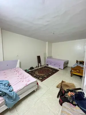 a room with two beds and other items on the floor at جبال الاردن in Amman