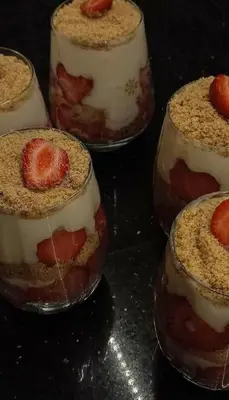 a group of desserts in glass jars with strawberries in them at جبال الاردن in Amman