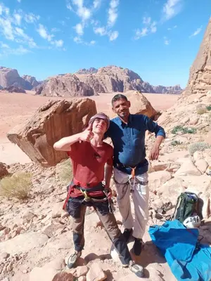 a man and a woman standing in the desert at Wadi Rum Hiking &camp in Wadi Rum