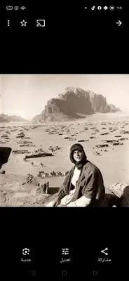 a man sitting on the shore of a body of water at Wadi Rum Hiking &camp in Wadi Rum