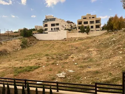 a building on a hill with buildings on it at Luxury spacious house in dabouq with parking in Amman