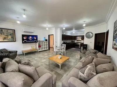 a large living room with couches and a table at Luxury spacious house in dabouq with parking in Amman