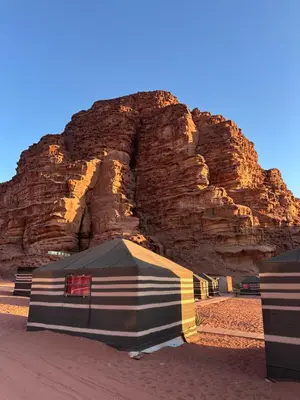 a large tent in front of a rocky mountain at Desert Star Camp in Wadi Rum