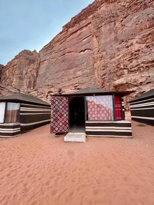 a building in the desert next to a cliff at Ruby Orbit Wadi Rum in Wadi Rum