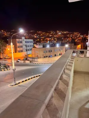 a bridge over a city street at night at Petra Rocks Hotel in Wadi Musa