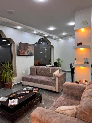a living room with two couches and a table at Petra Rocks Hotel in Wadi Musa