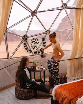 a man and a woman in a tent at Regency Bubble Wadi Rum in Wadi Rum