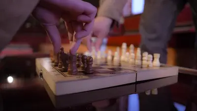 two people playing chess on a chess board at Rafiki Hostel in Wadi Musa