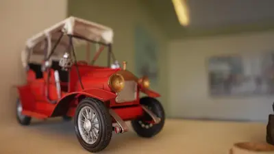 a red toy car parked in a room at Rafiki Hostel in Wadi Musa