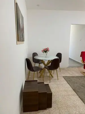 a dining room with a table and chairs at Ahlam Apartments in Amman