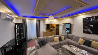 a living room with a couch and a tv at Royal in Aqaba