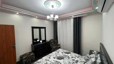 a bedroom with a bed and a dresser and a mirror at Royal in Aqaba