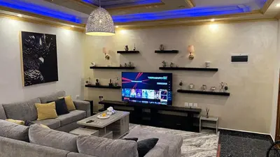 a living room with a couch and a flat screen tv at Royal in Aqaba