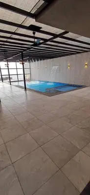 a large room with a swimming pool in a building at LAVA Resort Hot spring water in Mukāwir