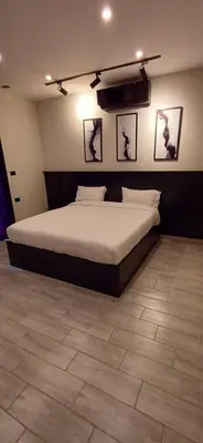 a bedroom with a bed and pictures on the wall at LAVA Resort Hot spring water in Mukāwir