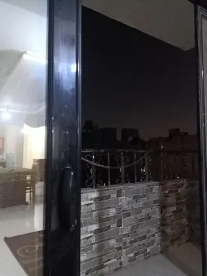 a room with a glass door and a brick wall at غباوي موتل in Az Zarqa