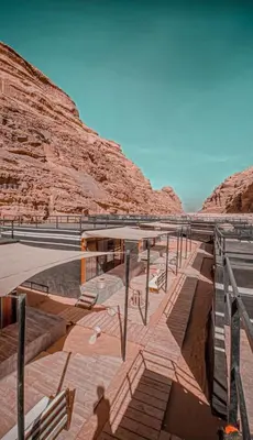a pool of water in a canyon with a mountain at مخيم خيال رم in Jurf ad Darāwīsh