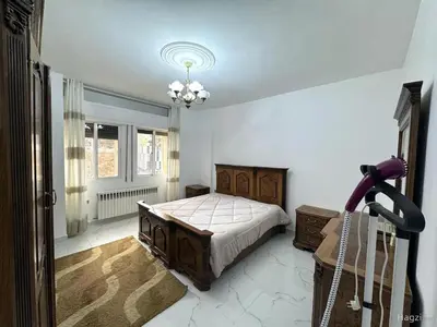 a bedroom with a bed and a chandelier at شقة مفروشة للايجار مميزه هادئه امنه ذات اطلاله رائعه in Amman