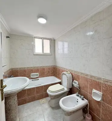 a bathroom with a toilet and a tub and a sink at شقة مفروشة للايجار مميزه هادئه امنه ذات اطلاله رائعه in Amman