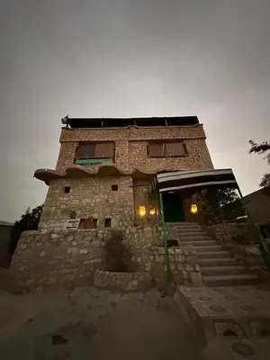 a brick building with a staircase in front of it at Dana bedouin Sky in Dana
