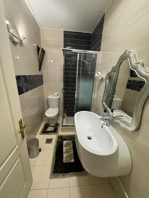 a bathroom with a sink and a toilet at Cozy 3-Bedroom Apartment in Abdoun in Amman
