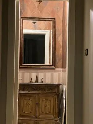 a bathroom with a sink and a mirror at Cozy 3-Bedroom Apartment in Abdoun in Amman