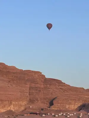 a kite flying in the sky over a canyon at Sands of time desert camp in Wadi Rum