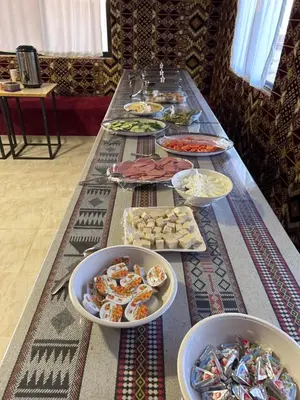 a long table with many plates of food on it at Sands of time desert camp in Wadi Rum