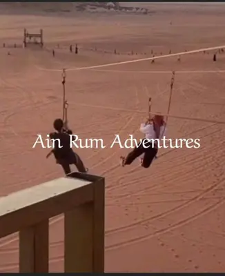 a person sitting on a swing on a beach at مغامرات عين رم in Jurf ad Darāwīsh