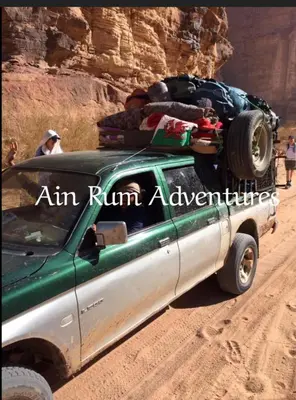 a truck parked on a dirt road in the desert at مغامرات عين رم in Jurf ad Darāwīsh