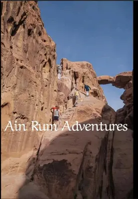 a person standing on a cliff in a canyon at مغامرات عين رم in Jurf ad Darāwīsh