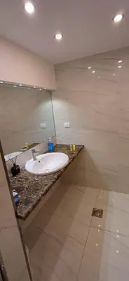 a bathroom with a white sink on a counter at LV luxury apartment Deir Ghbar in Amman