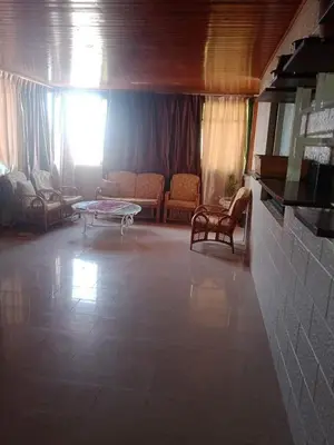 a living room with a couch and a table and chairs at bong chalet in Amman