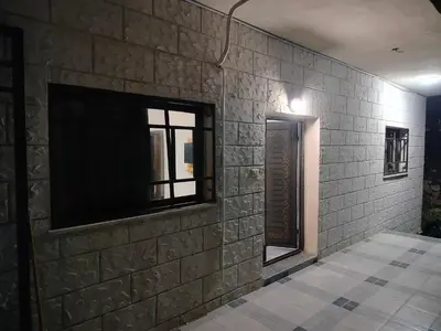 a wall with a flat screen tv on a brick wall at شقق ابو يزن عجلون بالقرب من محمية عجلون in Ajloun
