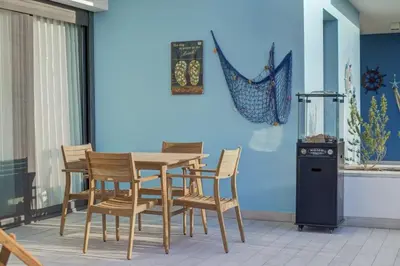 a dining room with a table and chairs at Emerald Beach Apartment in Aqaba