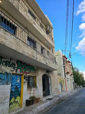 a building with graffiti on the side of it at Rainbow Retreat - 2BR in the heart of Old Amman in Amman