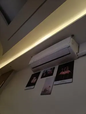 a light on the ceiling of a room with pictures at البويضه هاوس in Al Buwayḑah