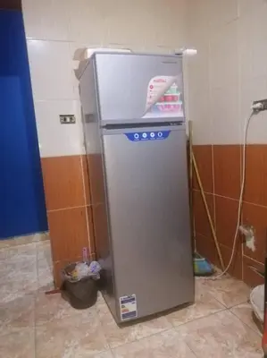 a small refrigerator sitting in a room at البويضه هاوس in Al Buwayḑah