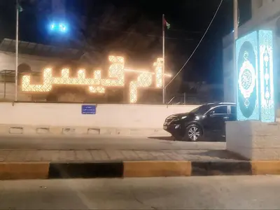 a car parked in front of a sign at night at Altamem apartment in Um Qeis