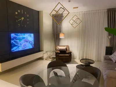 a living room with a large tv and a couch at Boulevard luxury Studio in Amman