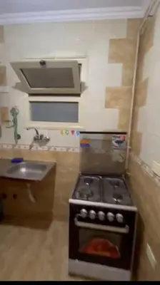 a small kitchen with a stove and a sink at الثغره هاوس in Abū al Lasan