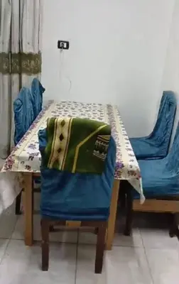 a table and a chair with a blanket on it at الثغره هاوس in Abū al Lasan