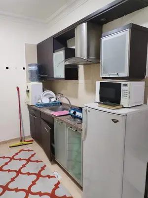 a kitchen with a white refrigerator and a microwave at عمان in Jurf ad Darāwīsh
