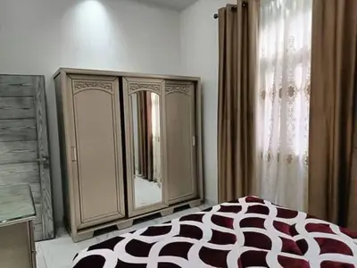 a bedroom with a bed and a dresser and a mirror at جرف العز هاوس in Jurf ad Darāwīsh