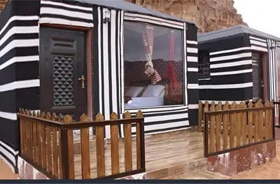 a black and white house with a wooden fence at Star Wars luxury camp in Wadi Rum