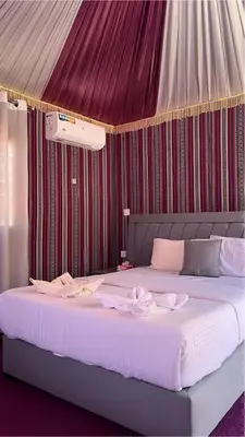 a bedroom with a large white bed with a canopy at Star Wars luxury camp in Wadi Rum