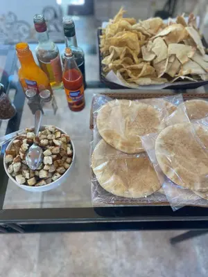 a table with plates of food and chips and drinks at Bedouin Luxury Camp in Wadi Rum