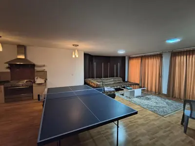a ping pong table in a living room at Shafa Badran Studio in Jurf ad Darāwīsh