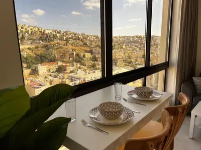a white table with two cups and plates on it at Brand new, Modern, Breathtaking view, just for you in Amman