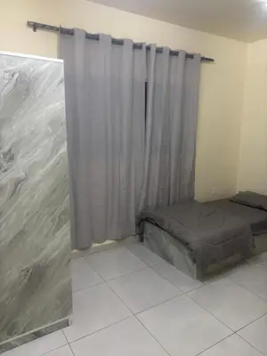 a small bedroom with a bed and a curtain at Bubbles in Jurf ad Darāwīsh